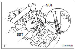 REMOVE EXHAUST VALVE GUIDE BUSH